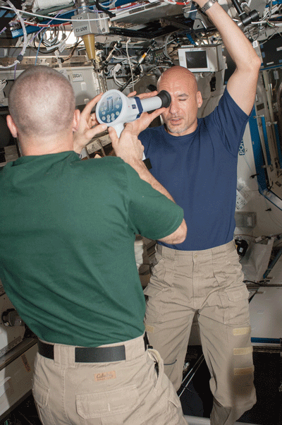 Astronaut Luca Parmitano collects fundoscopic images with the help of astronaut Chris Cassidy for the Ocular Health experiment.