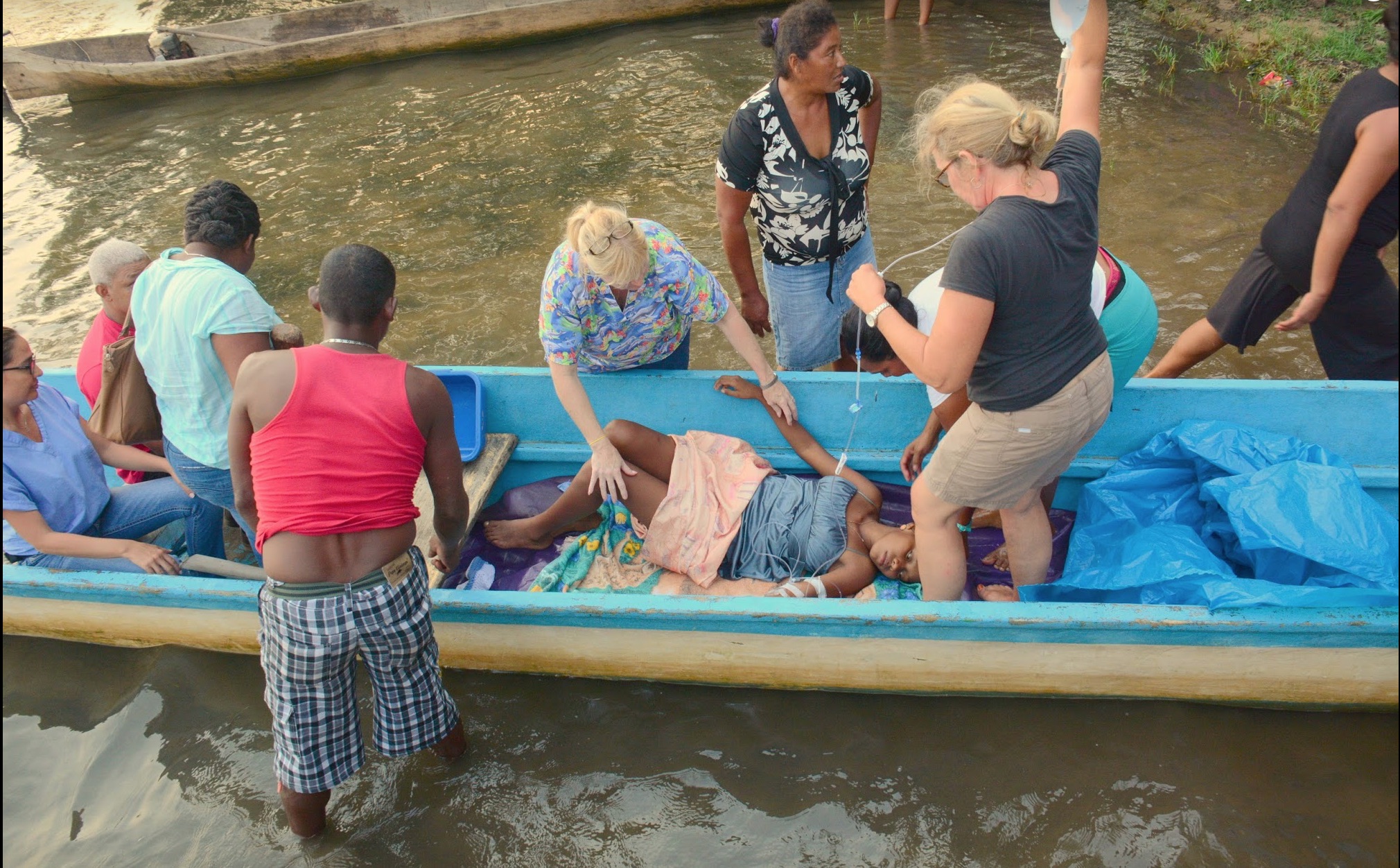 FIGURE 3. The transfer up-river is prepped for a 15-year-old female with an acute bowel obstruction secondary to an ascariasis infection.